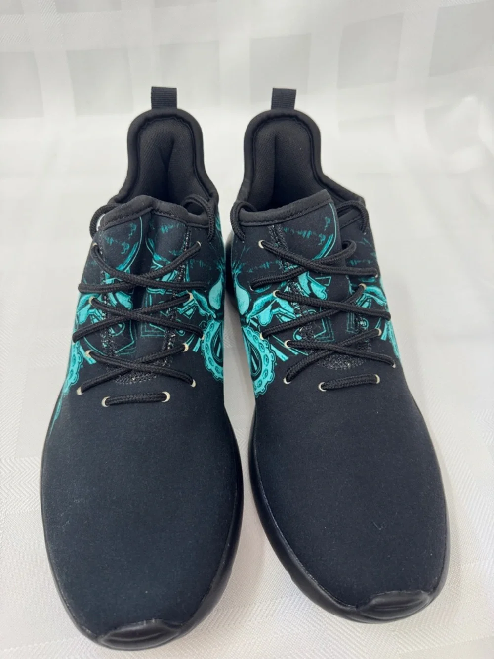 Unisex Black Lightweight Sneakers with Teal Skull Accent
